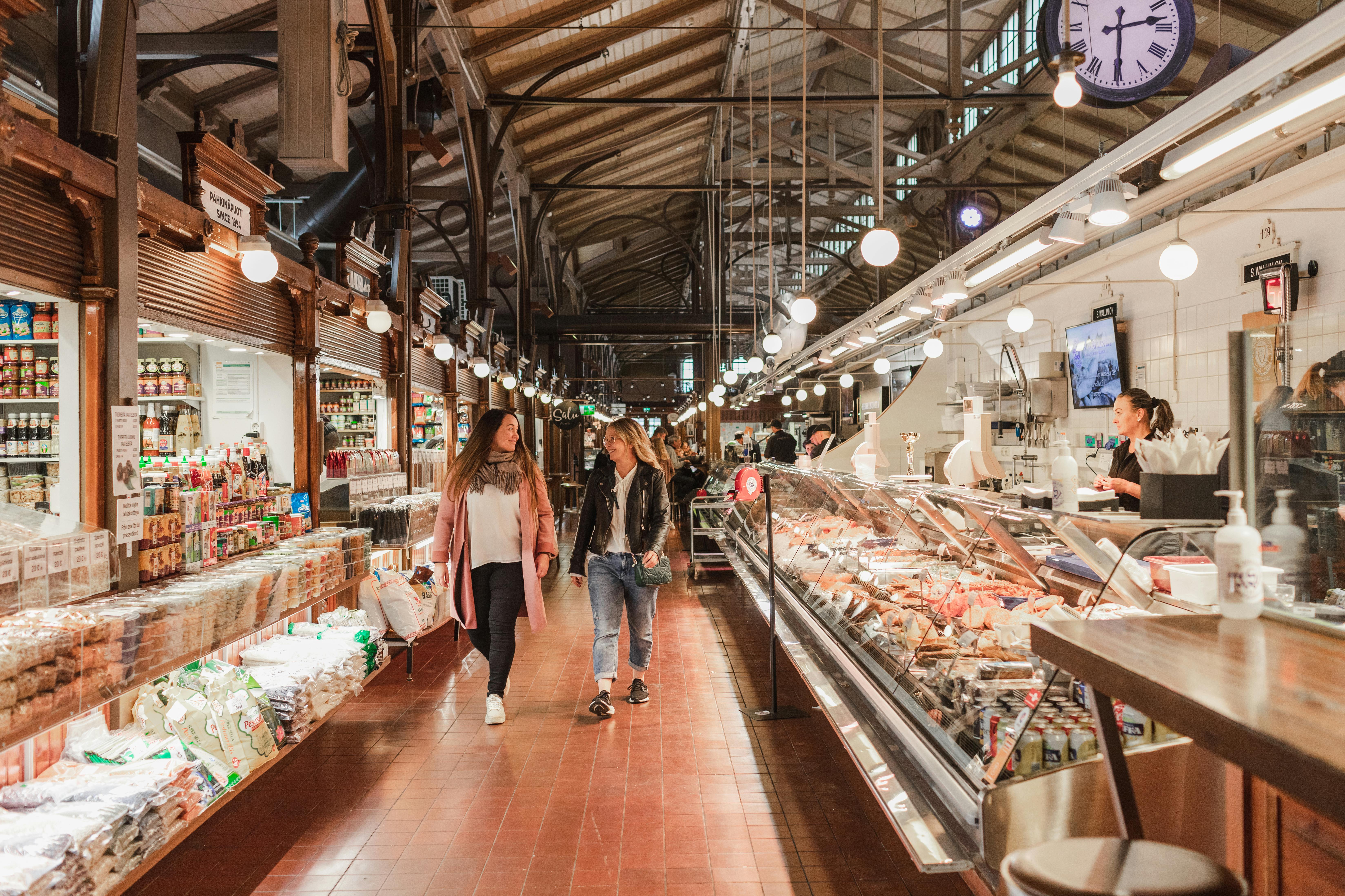 Friends exploring Turku Market Hall.