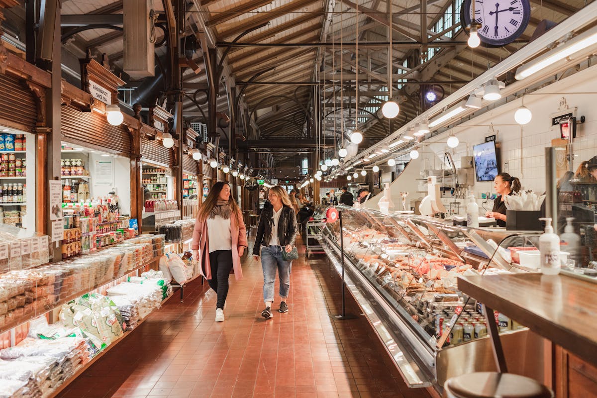 Friends exploring Turku Market Hall.