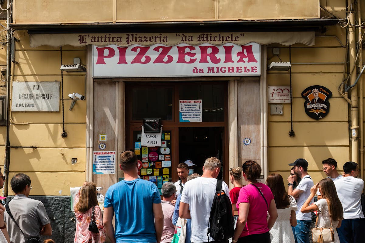 Ihmiset odottavat kuuluisan L'antica Pizzeria da Michelen ulkopuolella Napolissa, Italiassa