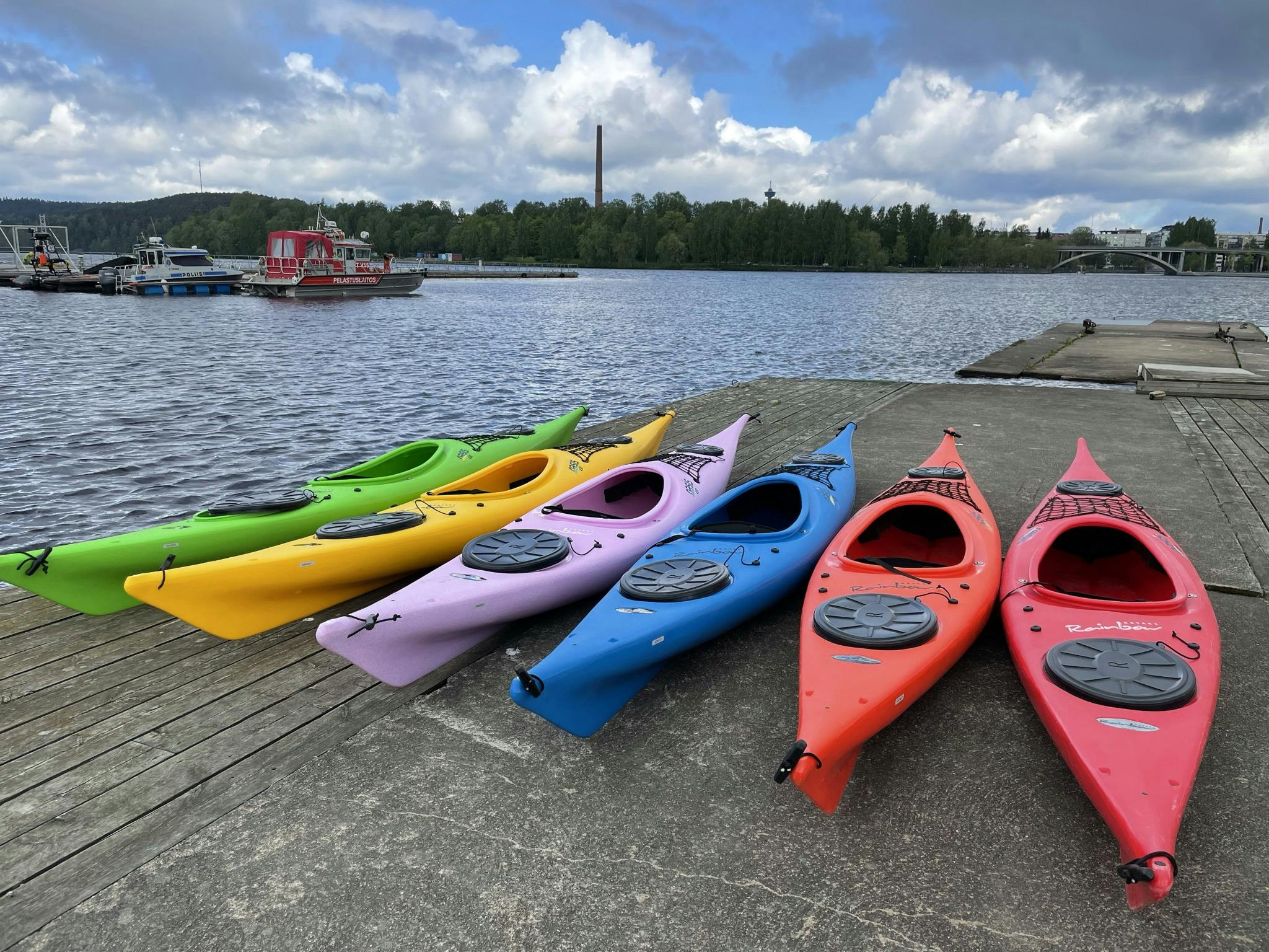 Multiple color line of kayaks.